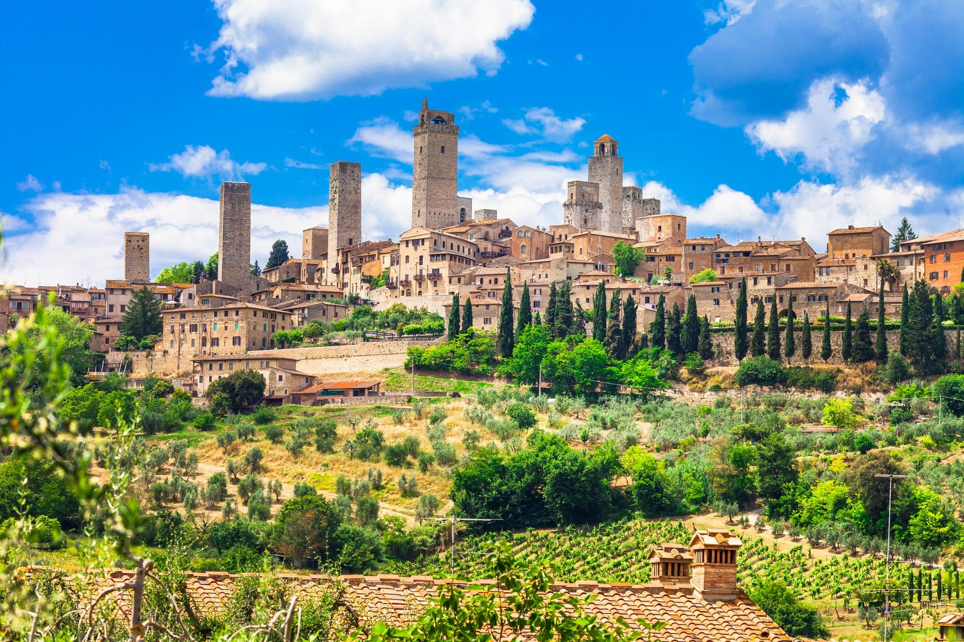 Architecture in San Gimignano in sunny weather with few clouds