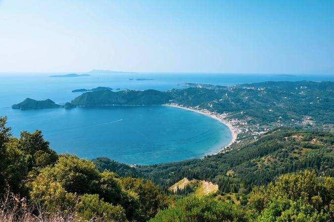 Corfu island covered with forests and greenery, surrounded by sea