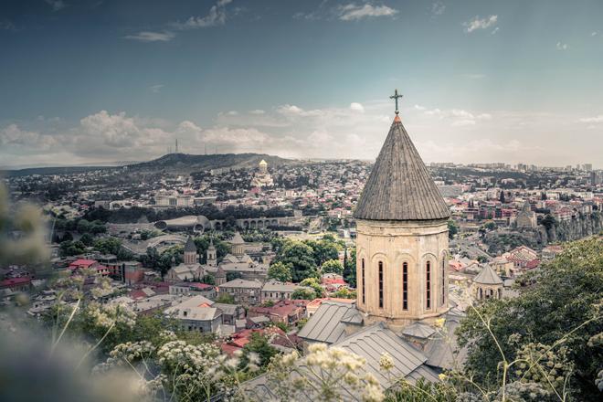 Tbilisi, Georgia: view of the city with the church tower in the foreground.

