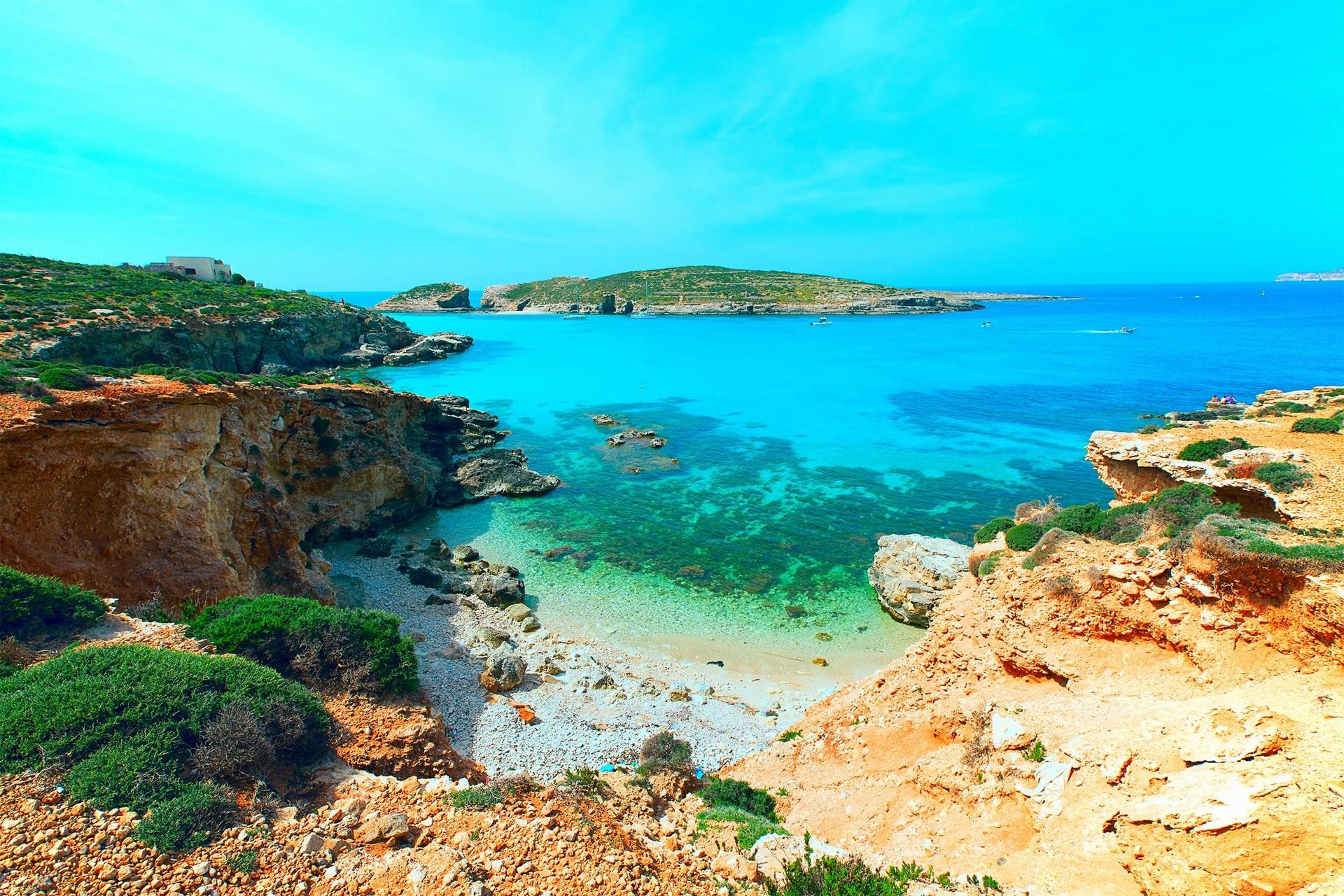 Beach with turquise water near Gozo with nice weather and blue sky