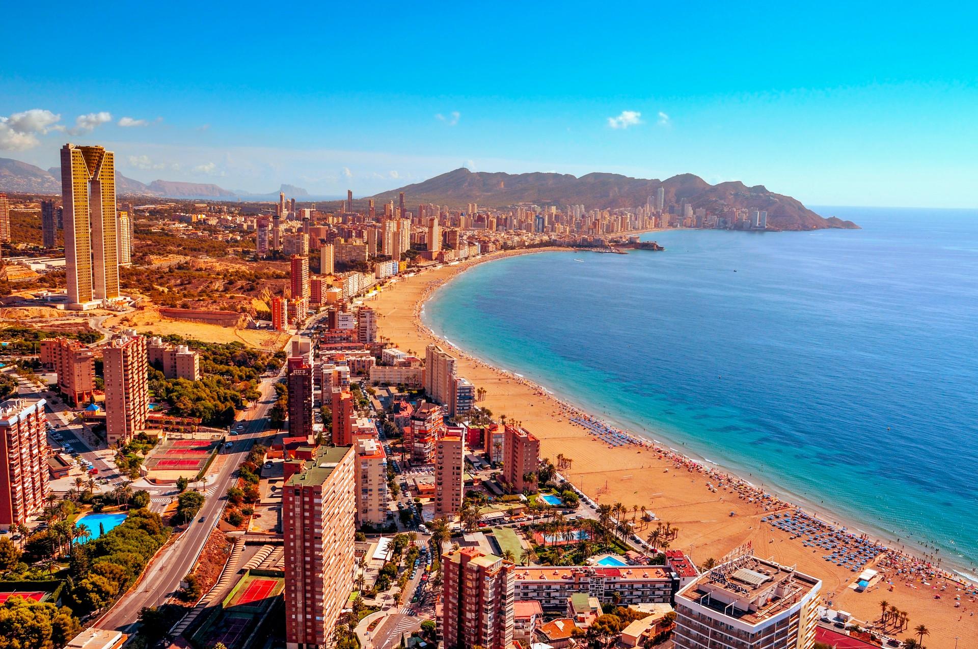 Aerial view of beach in Benidorm in sunny weather with few clouds