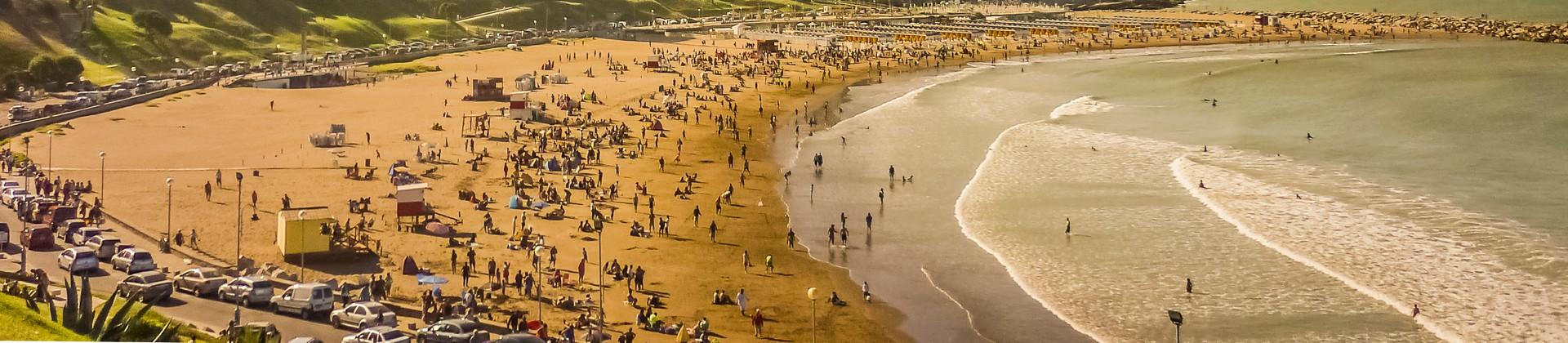 Aerial view of beach in Mar del Plata in sunny weather with few clouds