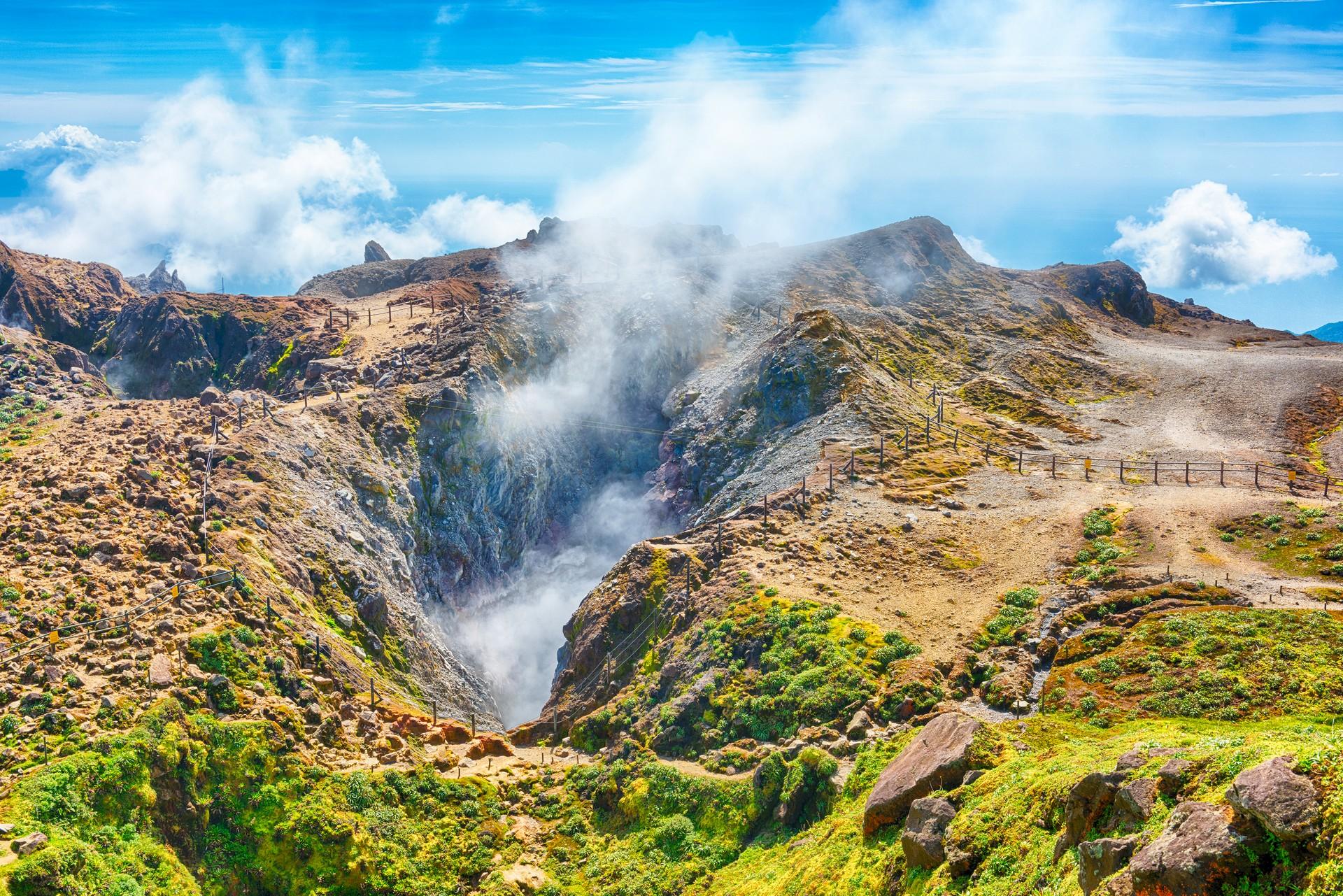 Mountain range in Guadeloupe on a sunny day with some clouds