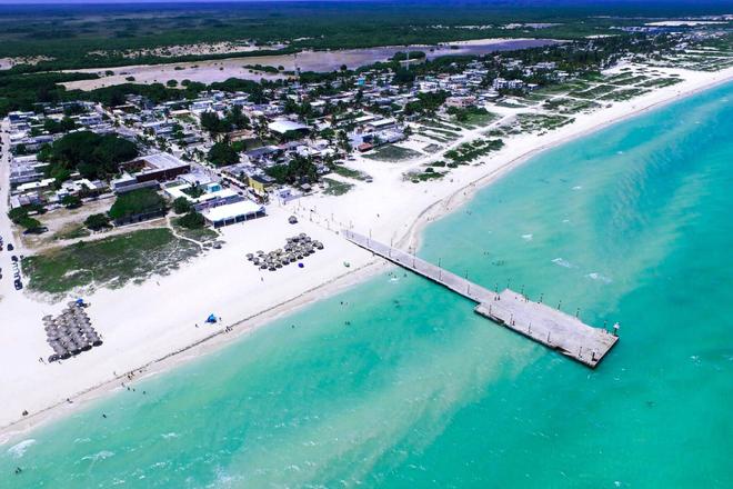 View of Yucatán peninsula, beach, houses, sea and pier