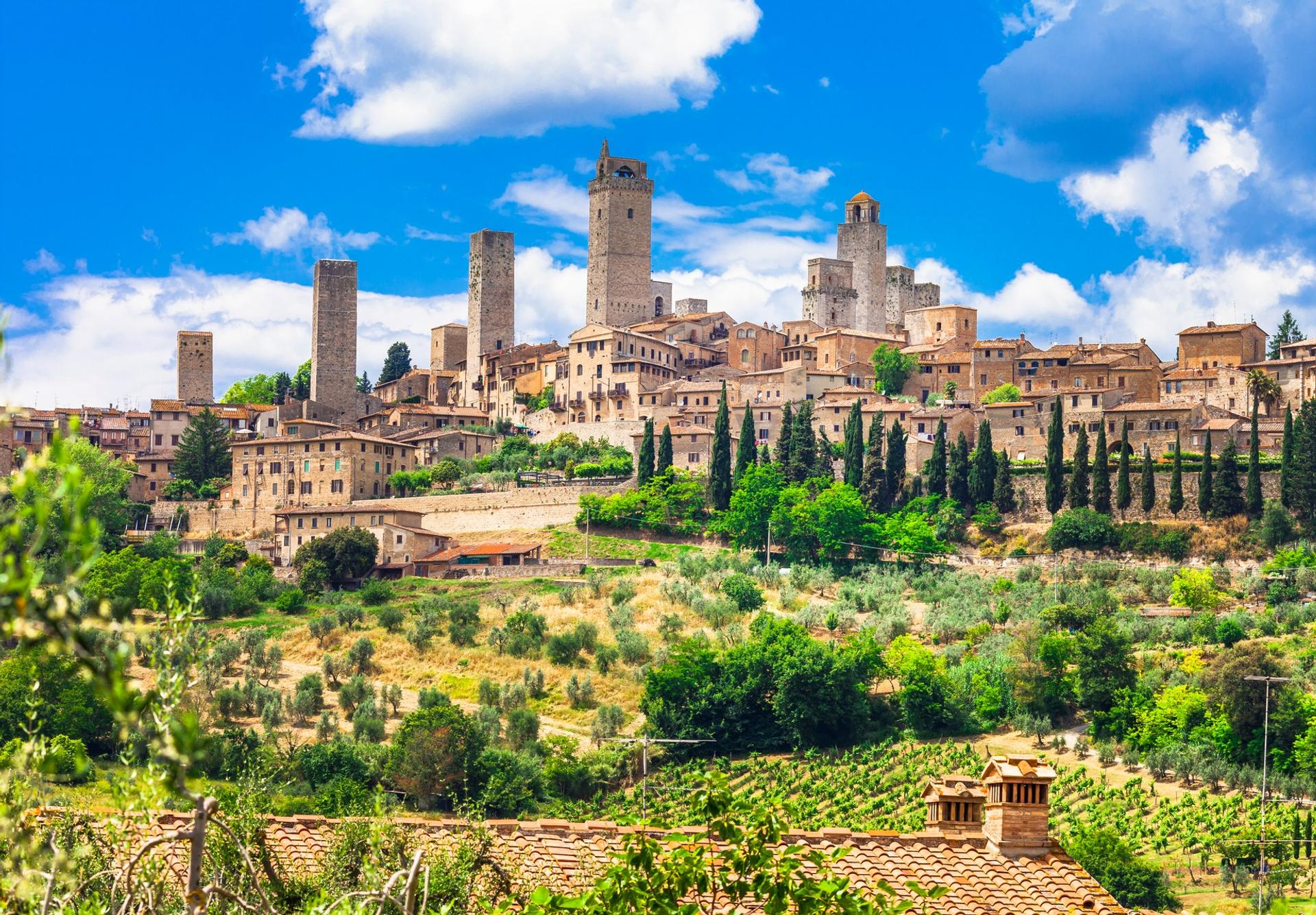 Architecture in San Gimignano in sunny weather with few clouds
