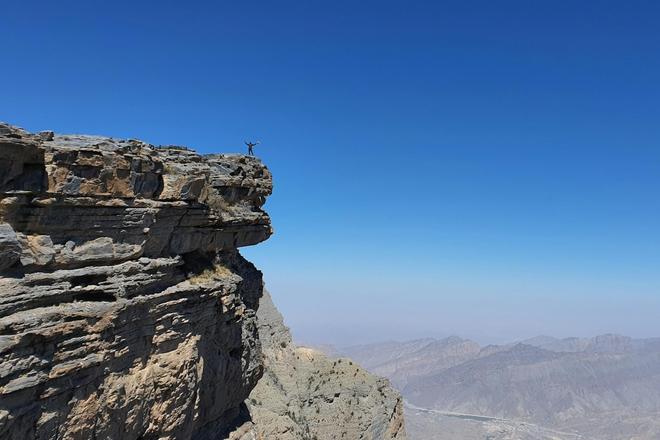 A person on top of the Jebel Shams mountain in Oman