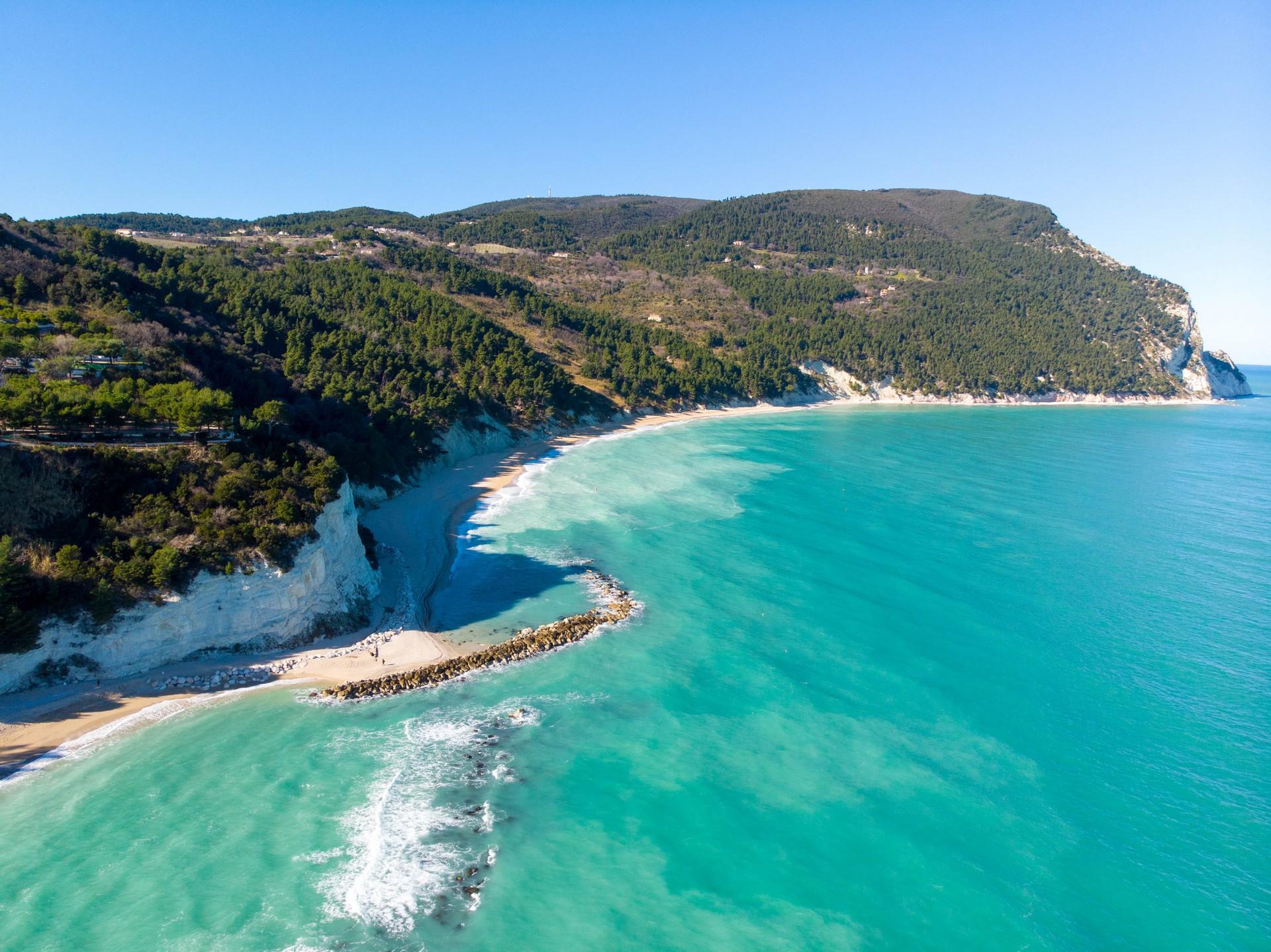 Beach with turquise water near Numana with nice weather and blue sky