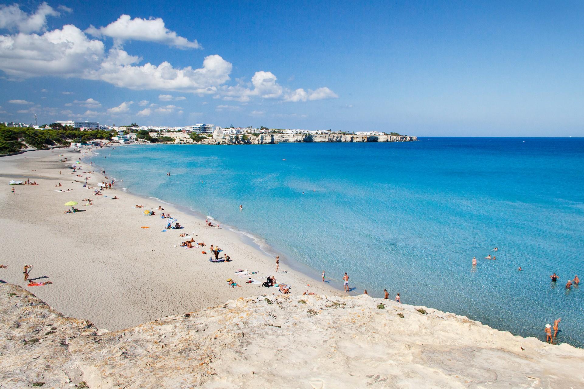 Beach and port in Torre dell'Orso on a sunny day with some clouds