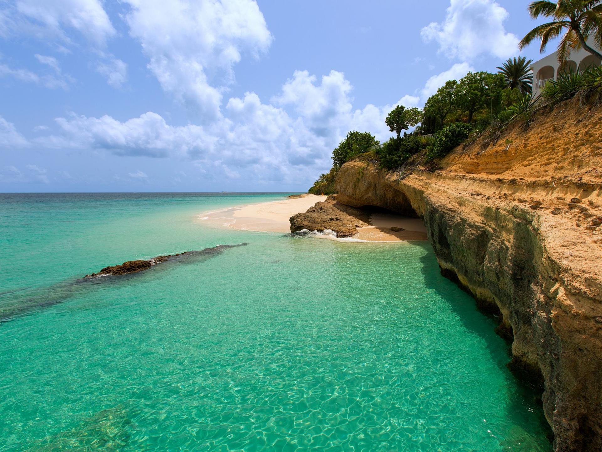 Beach with turquise water in Anguilla on a day with cloudy weather