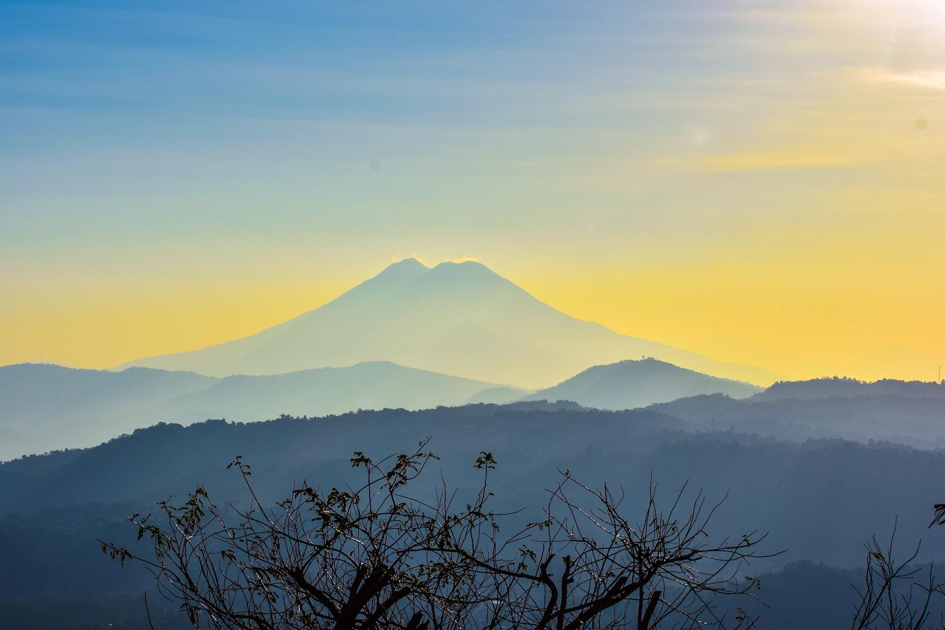 El Salvador: the outline of a volcano against a blue-yellow sky