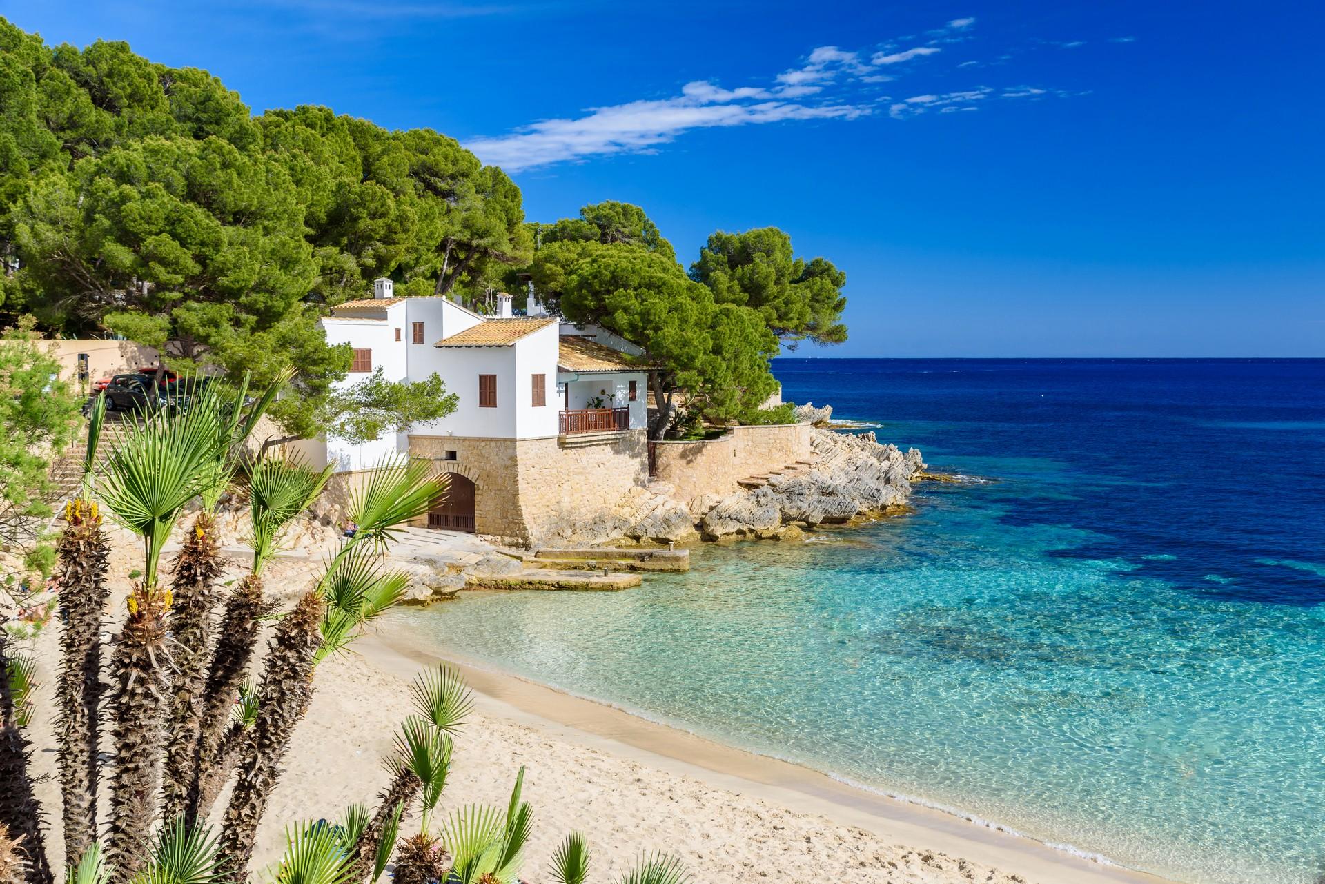 Amazing beach with turquise water in Cala Rajada in partly cloudy weather