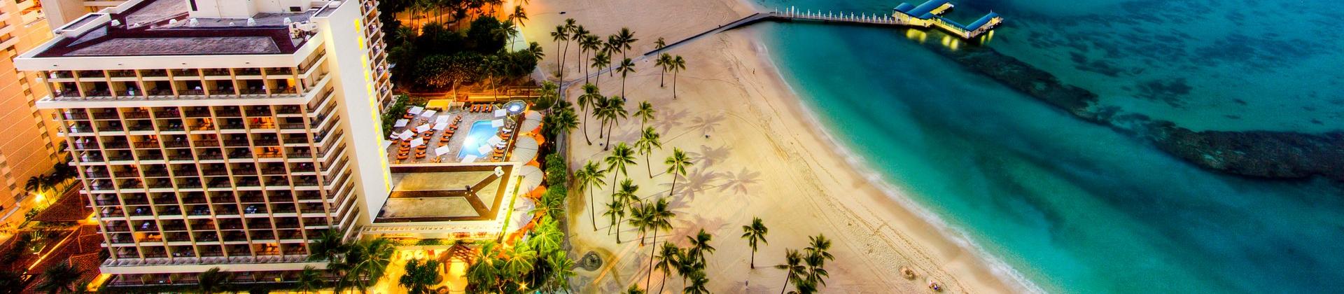 Nice beach by the sea with turquise water in Waikiki at sunset time