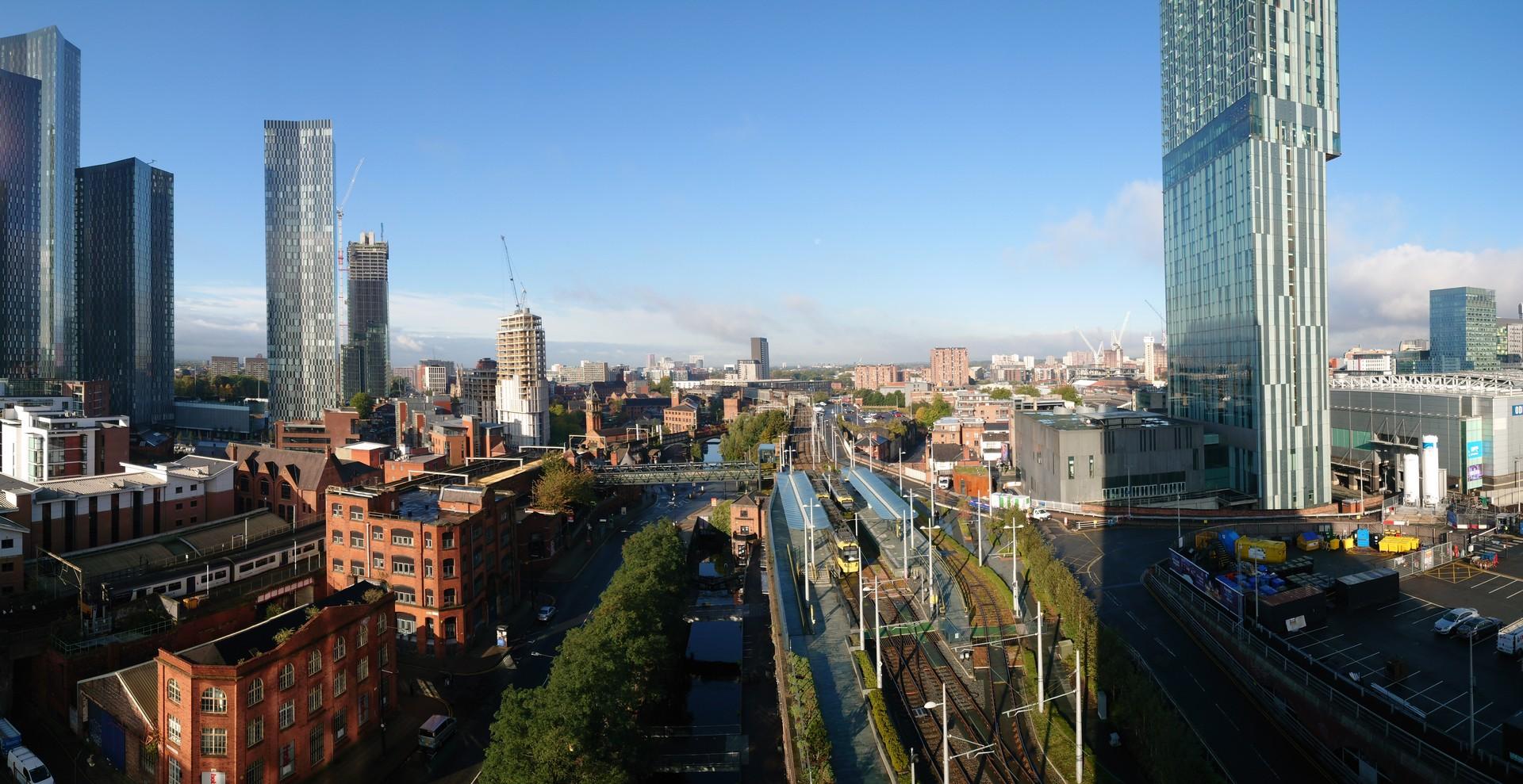 Aerial view of architecture in Manchester on a sunny day with some clouds