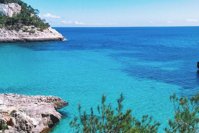 View of a crystal-clear sea and some cliffs in Menorca