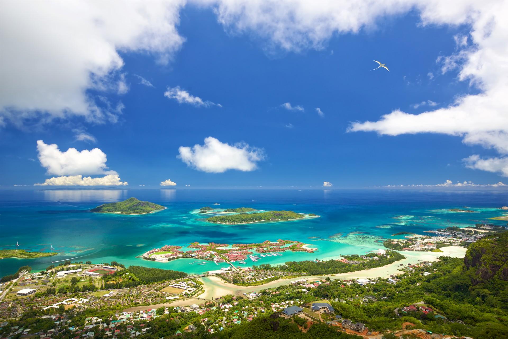 Aerial view of beach in Mahé in sunny weather with few clouds