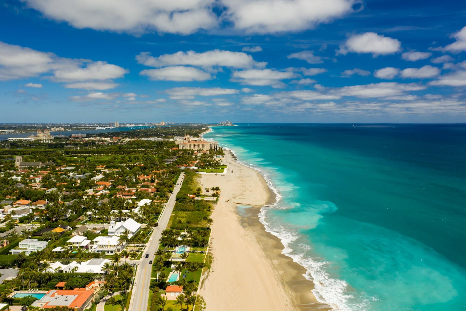 Beach with turquise sea in West Palm Beach in partly cloudy weather