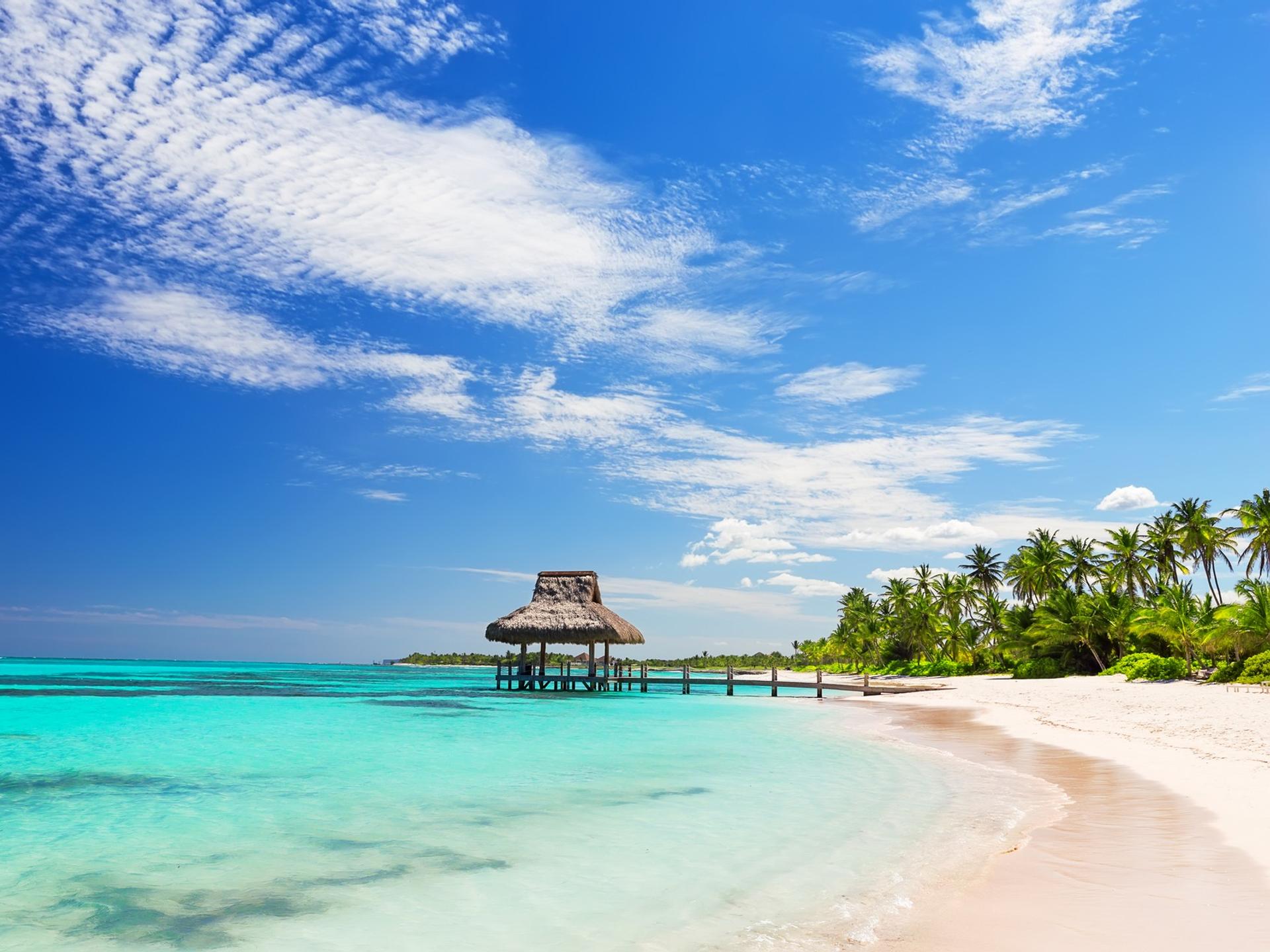 Enjoyable beach with turquise water in Punta Cana on a sunny day with some clouds