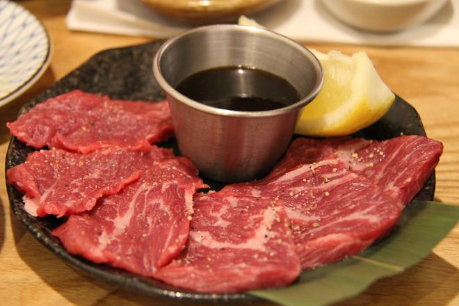 Japanese wagyu beef: slices on a plate with sauce and lemon.