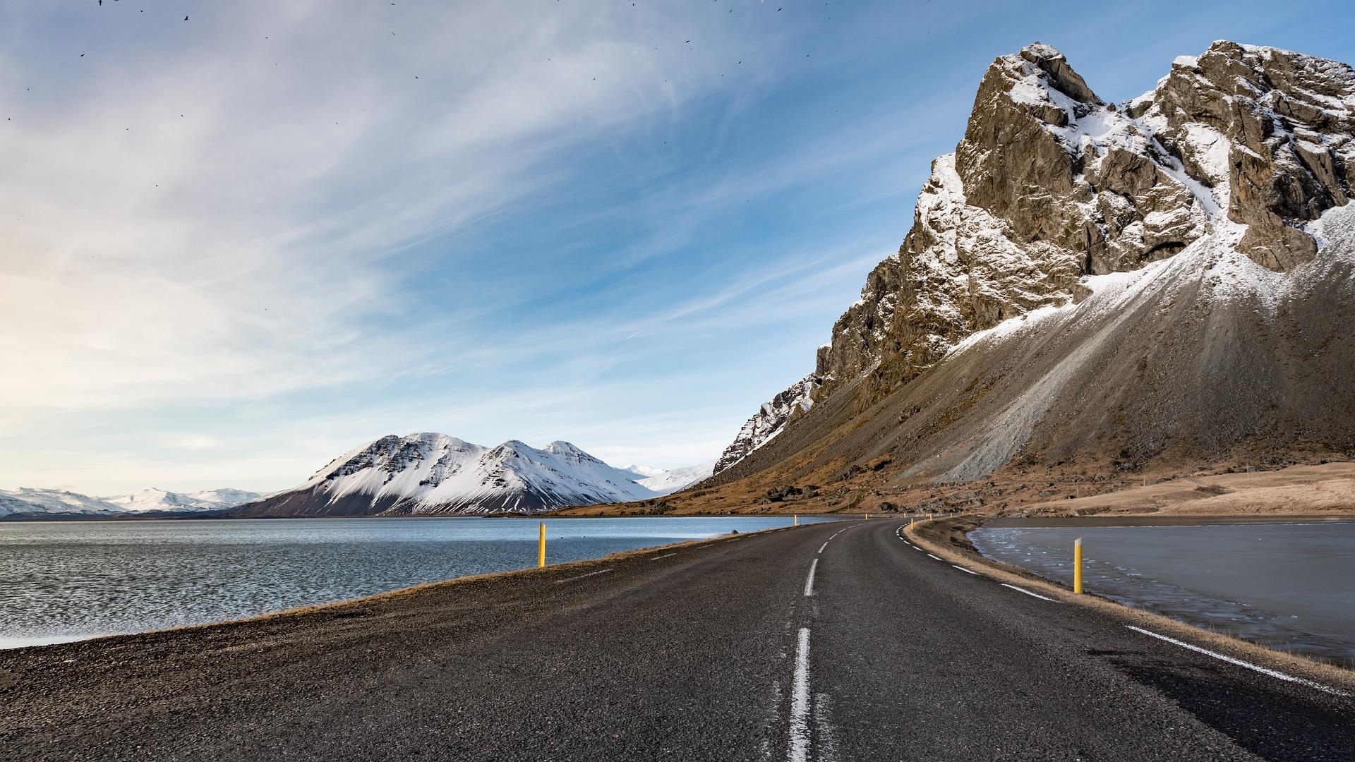 Iceland: road by the water with mountains in the background