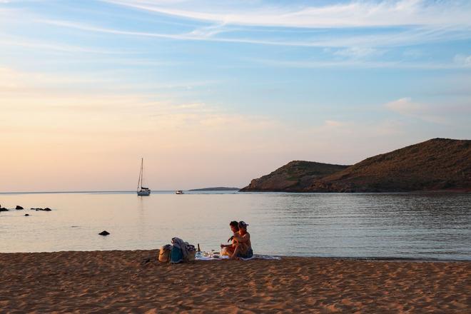 People enjoying the golden beach in Menorca