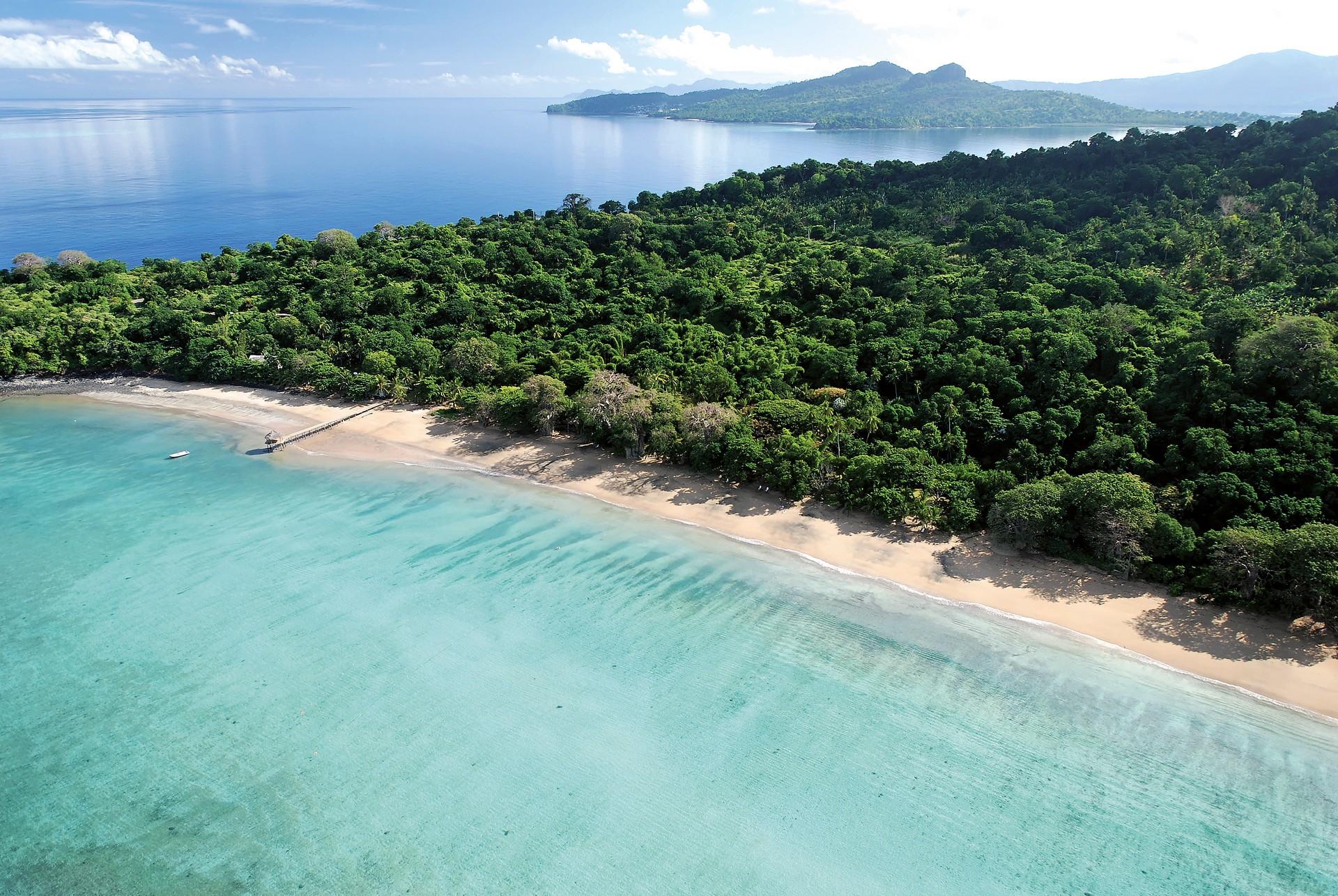 Beach with turquise water in Mayotte on a sunny day with some clouds