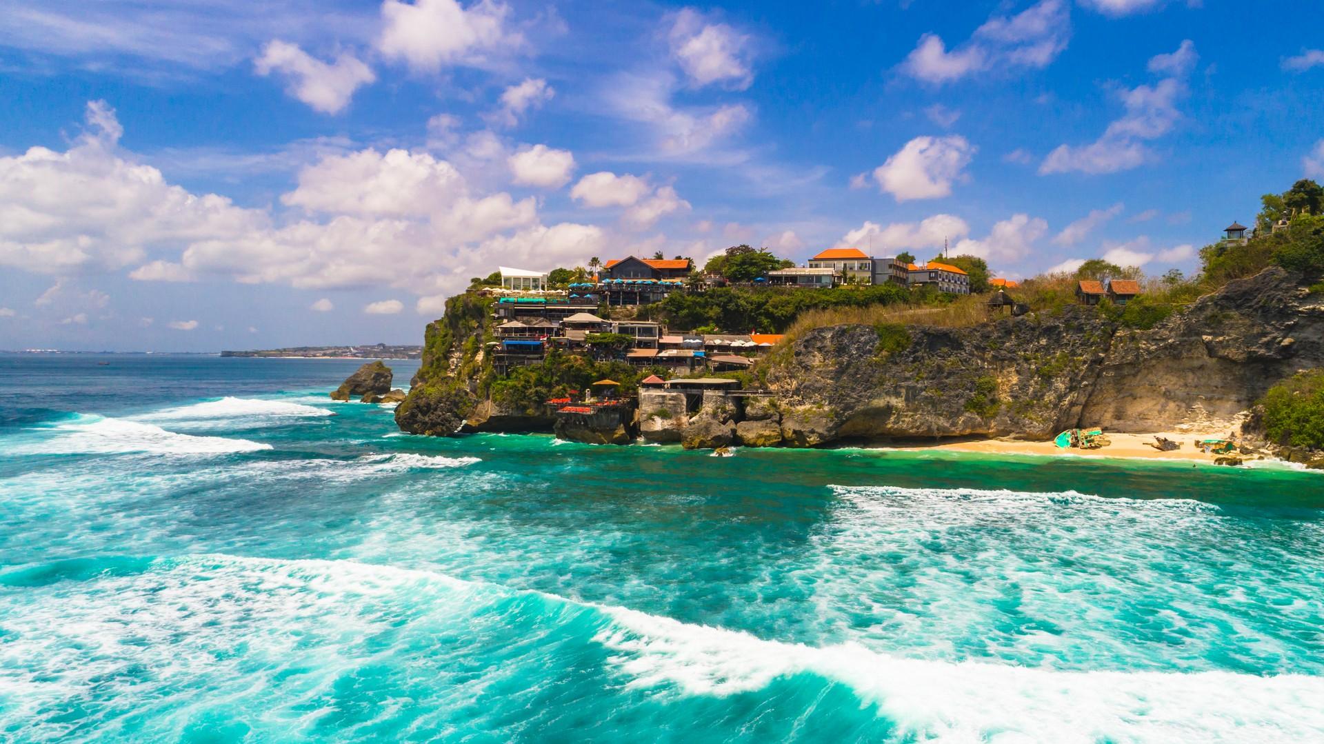 Beach in Uluwatu in sunny weather with few clouds