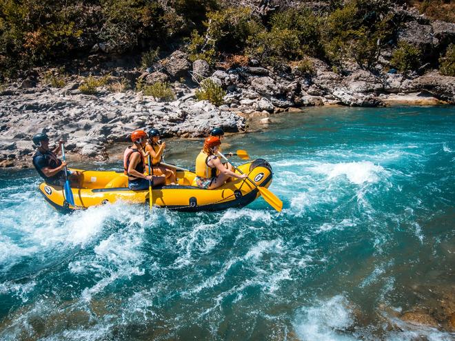 Rafting: group of people on a raft on the river.