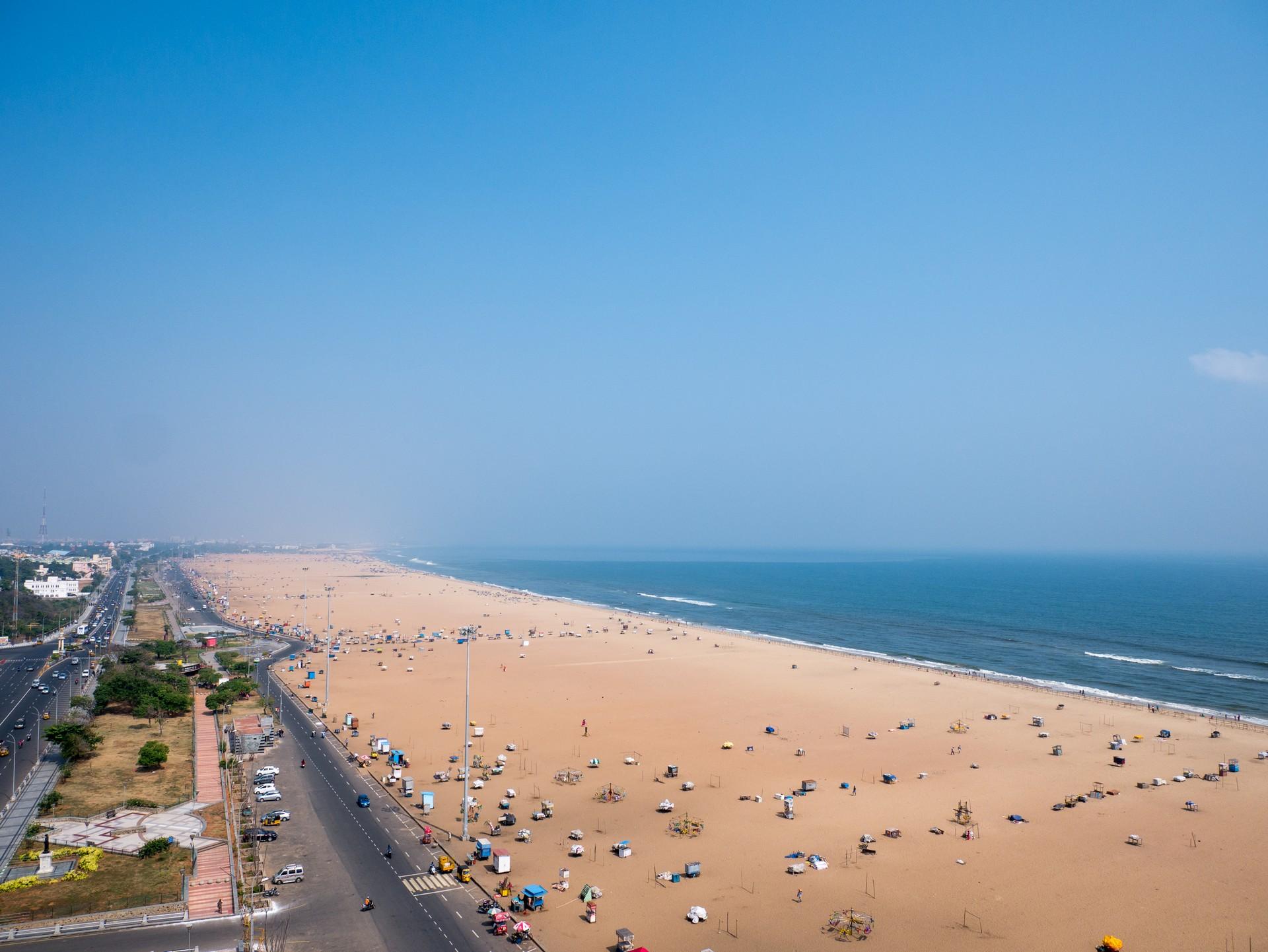 Aerial view of beach with a lot of people in Chennai on a clear sky day