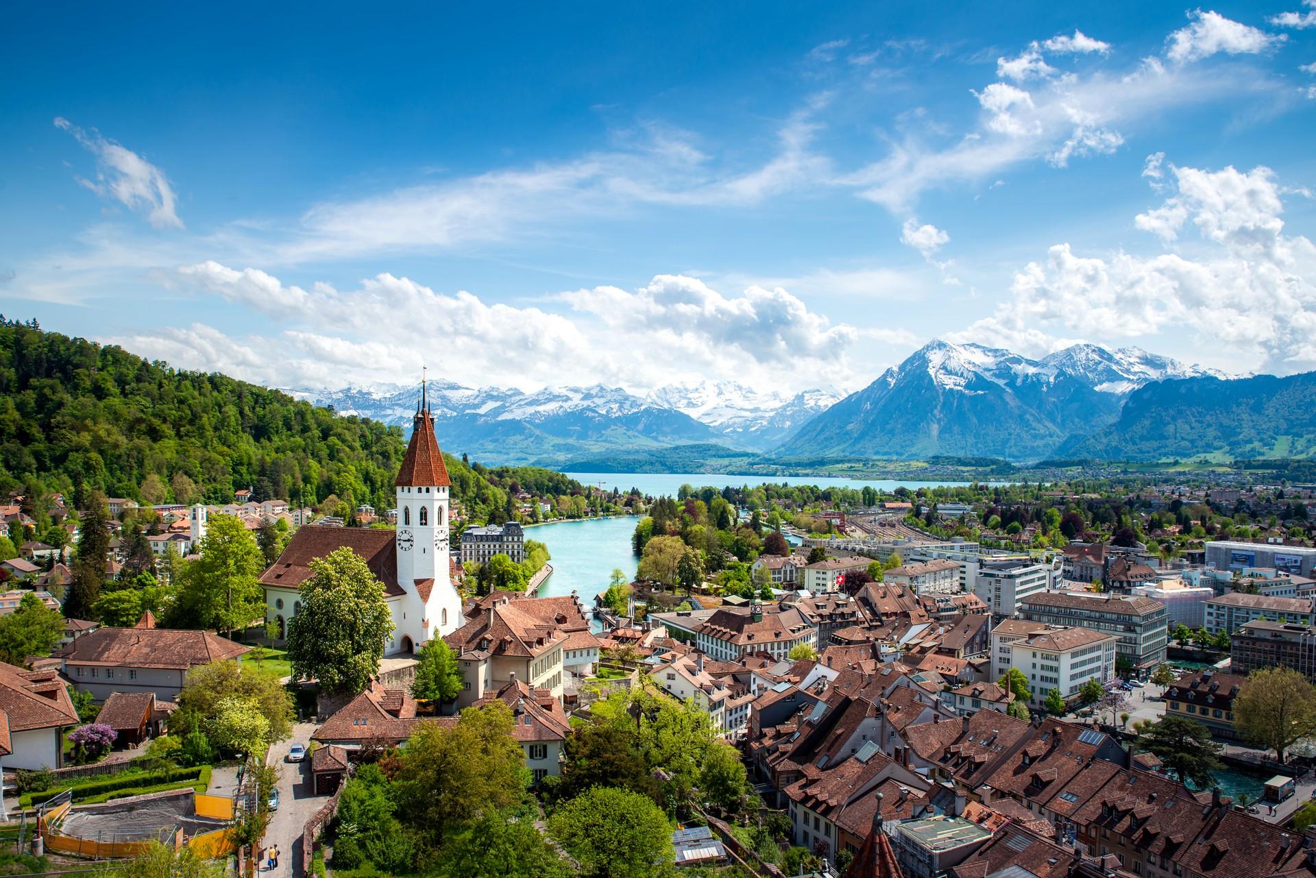 Aerial view of mountain range in Switzerland in sunny weather with few clouds