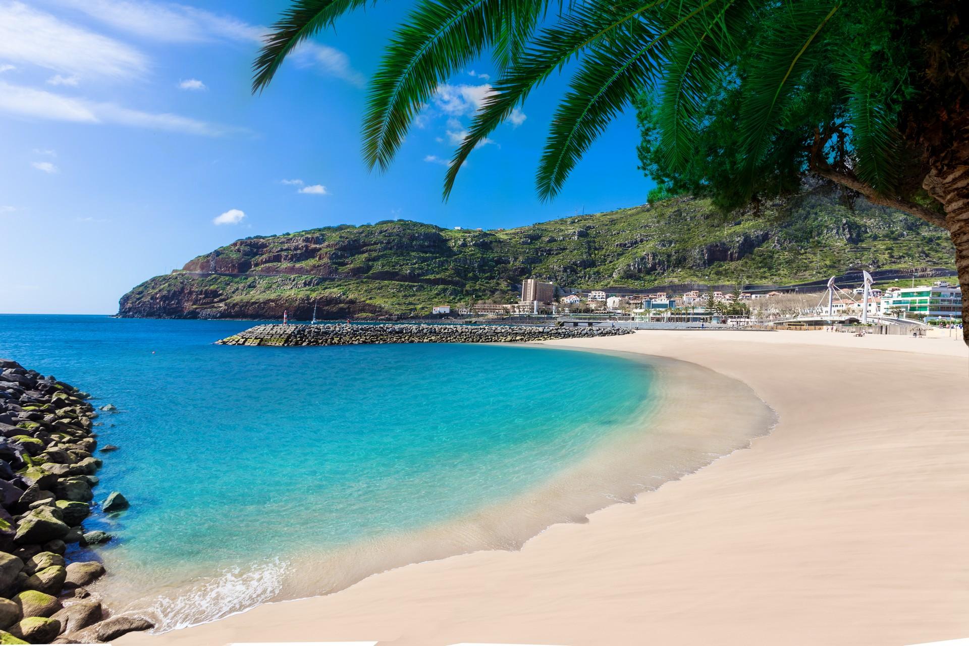 Amazing beach with turquise sea in Machico on a sunny day with some clouds