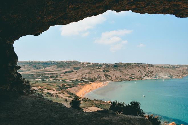 Ramla Bay, Gozo, Malta: view of the beach from a rock hole.