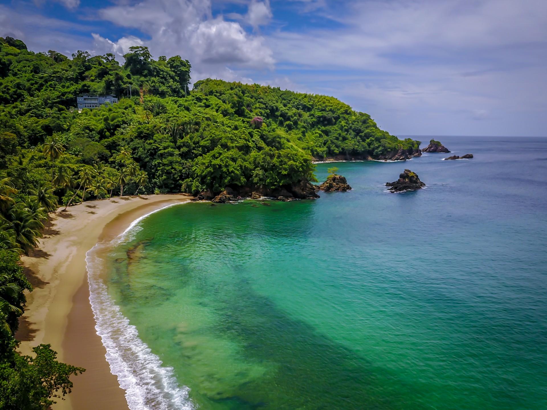 Nice beach by the sea with turquise water in Trinidad and Tobago in sunny weather with few clouds