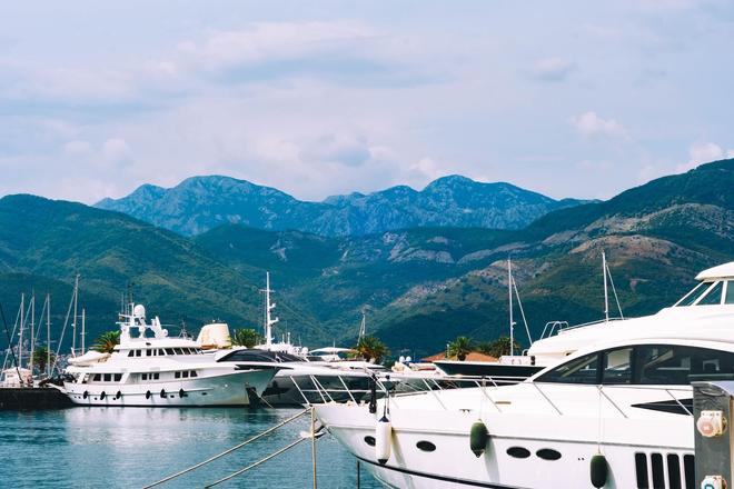 View of ferries on the water and mountains in the background