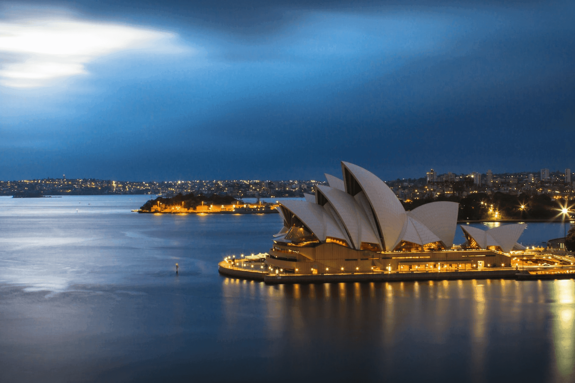 The night city of Sydney full of lights surrounded by the sea