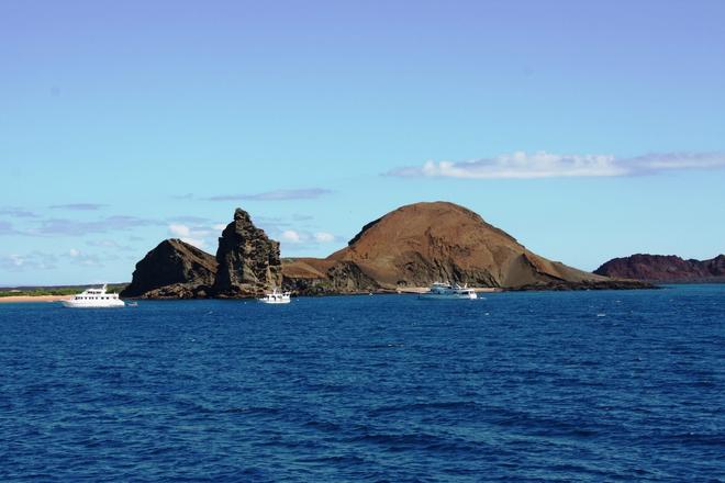 View of the sea, boats and a volcanic islands in the Galapagos