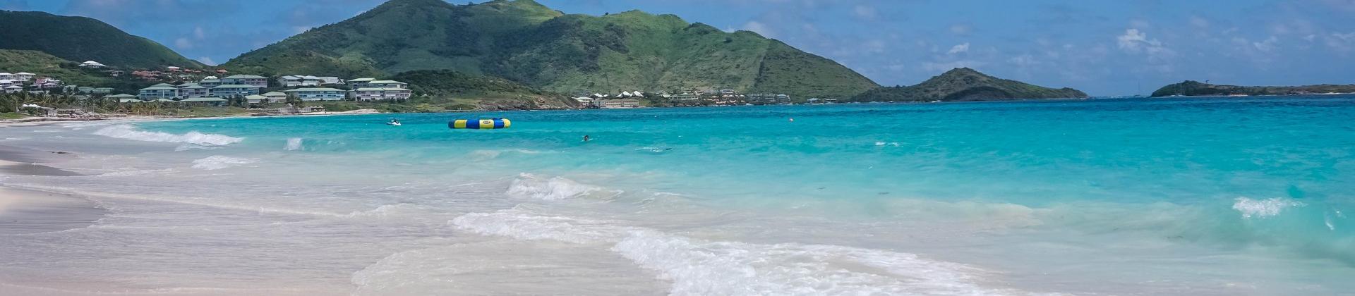 Beach with turquise water in Orient Bay in sunny weather with few clouds