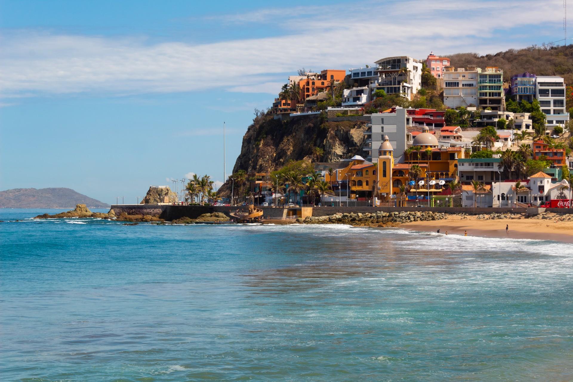 Beach and architecture in Mazatlán in partly cloudy weather