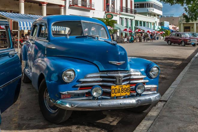 View of a blue vintage american car parked in a city, Cuba