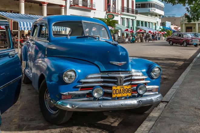 View of a blue vintage american car parked in a city, Cuba