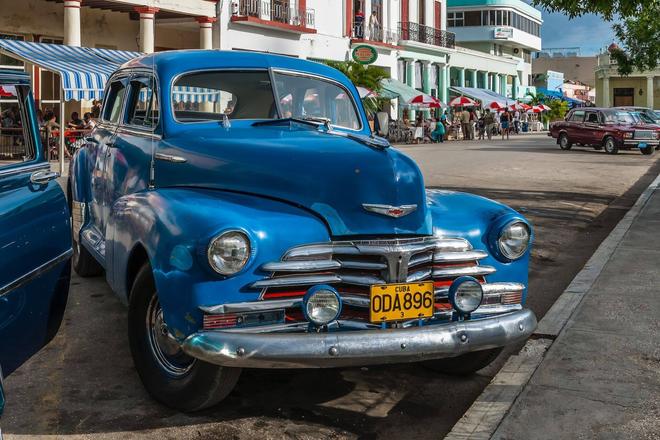 View of a blue vintage american car parked in a city, Cuba