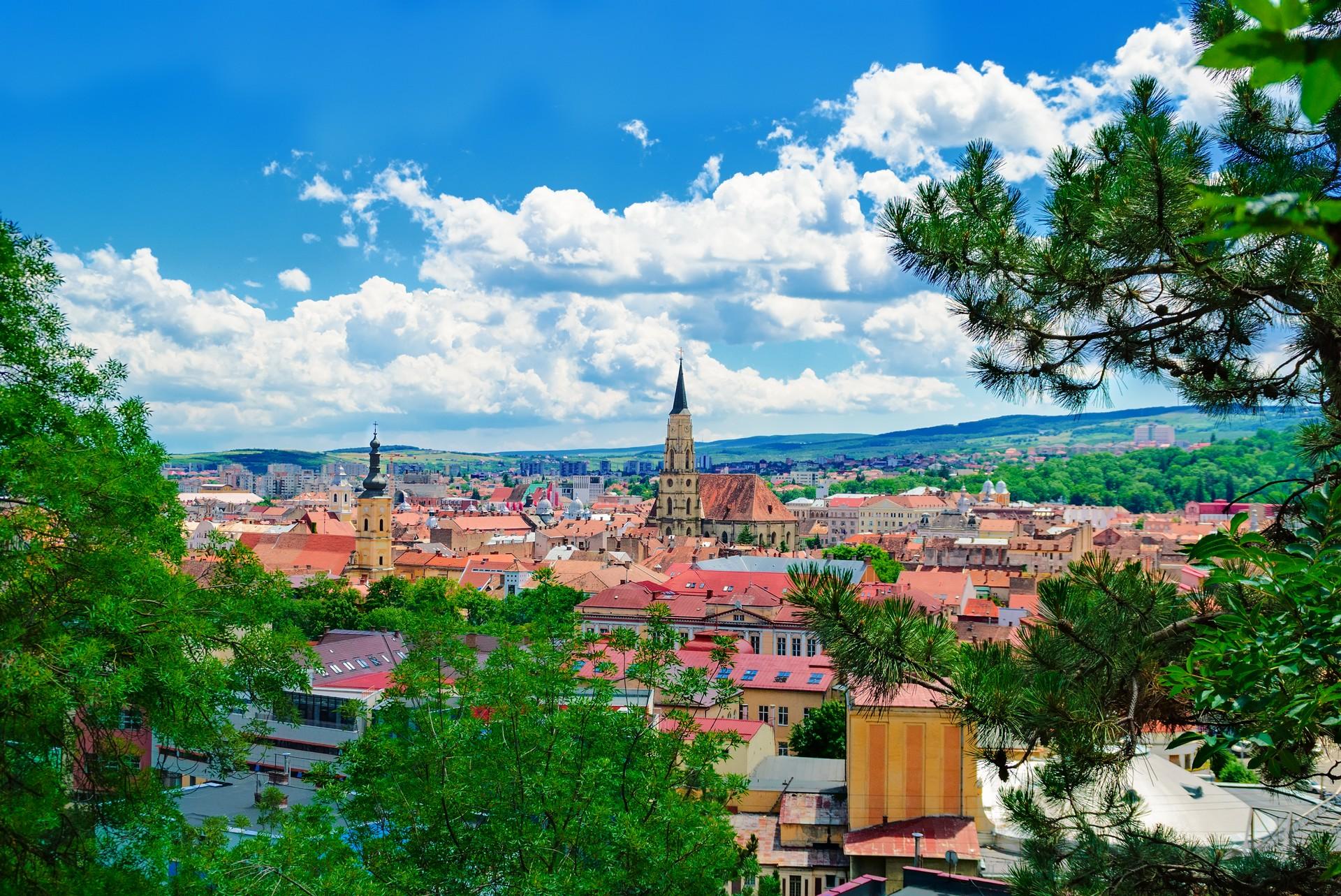 Aerial view of architecture in Cluj-Napoca in sunny weather with few clouds