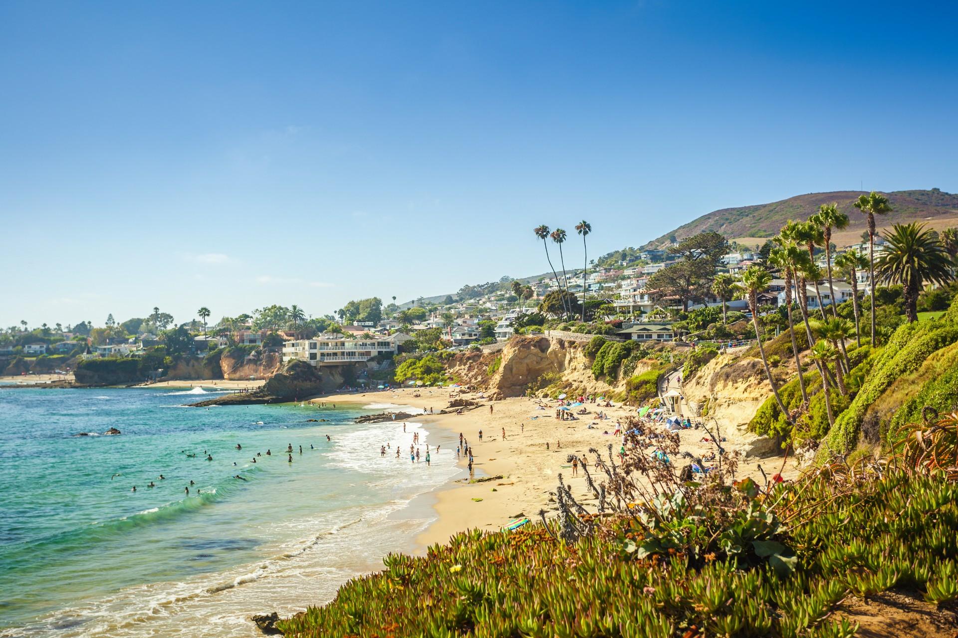 Beach with a lot of people in Laguna Beach with nice weather and blue sky
