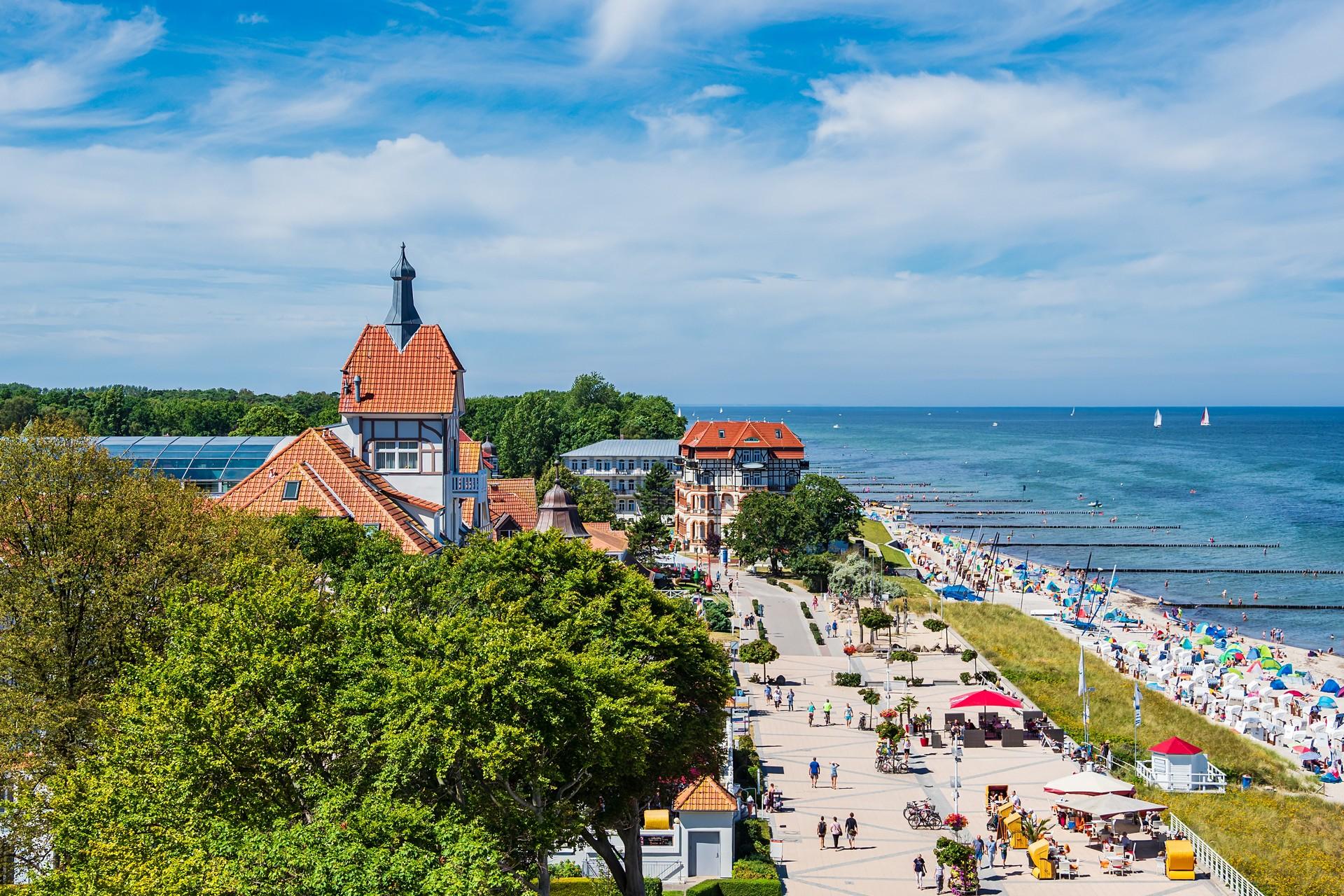 People on the beach and architecture in Kühlungsborn with cloudy sky
