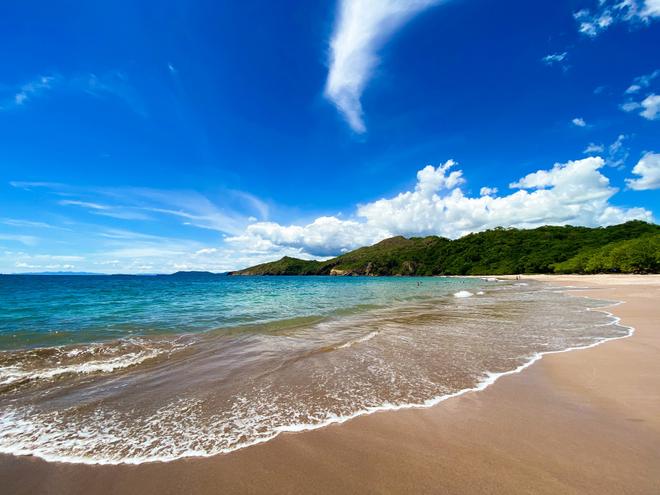 Costa Rica coast with azure sea and gentle waves.
