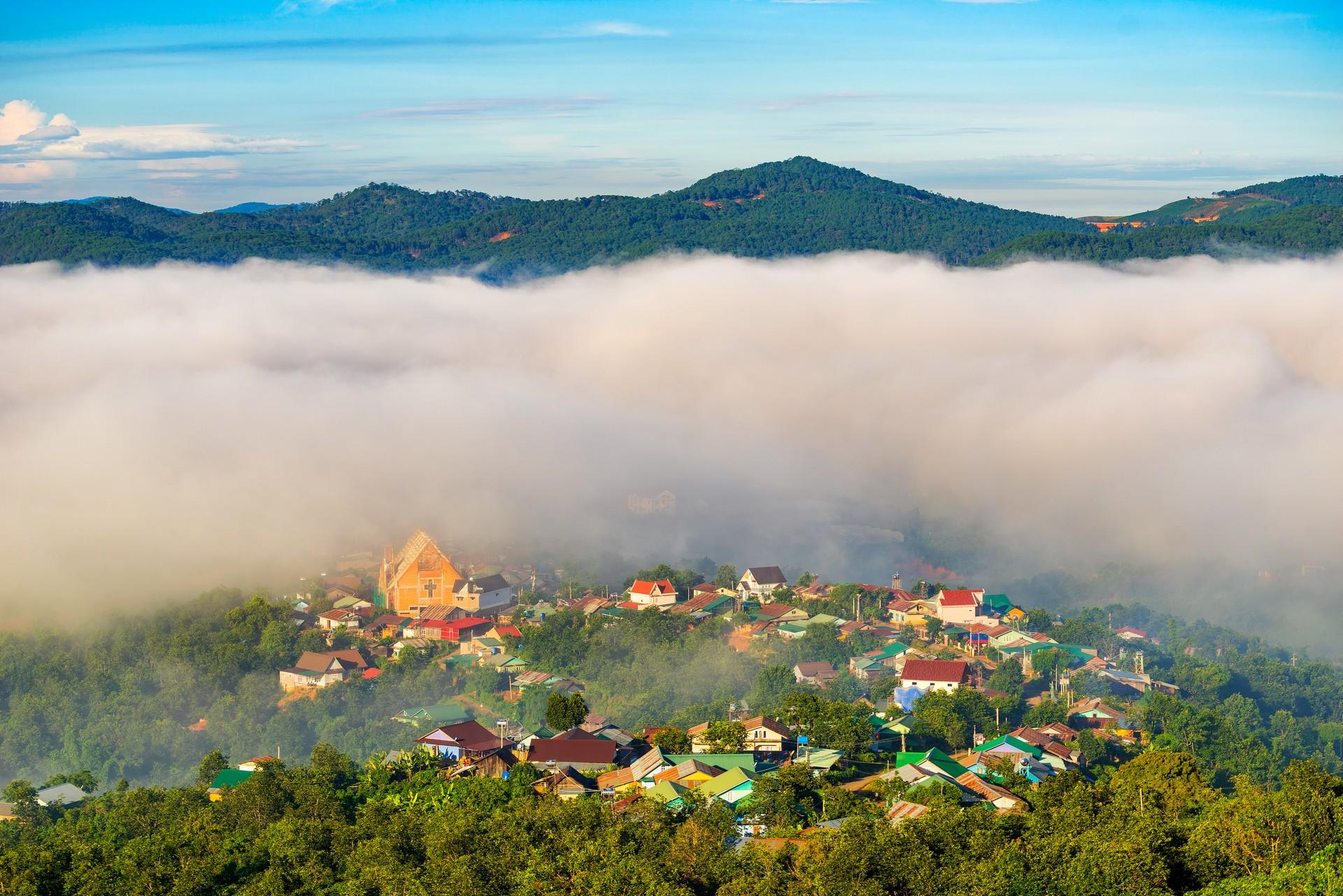Aerial view of mountain range in Da Lat in sunny weather with few clouds