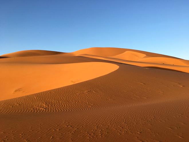 Erg Shigaga in Marocco: sand dunes and blue sky.