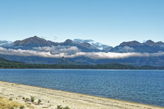 New Zealand: Lake Manapouri with mountains in the background.
 