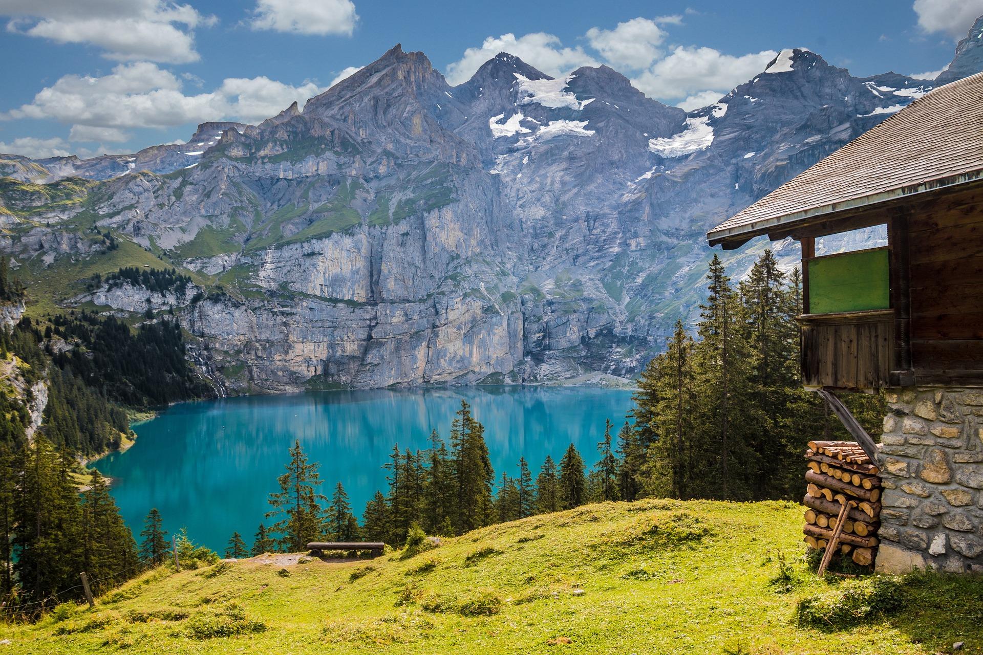 Switzerland: chalet on a lake overlooking the Alps.