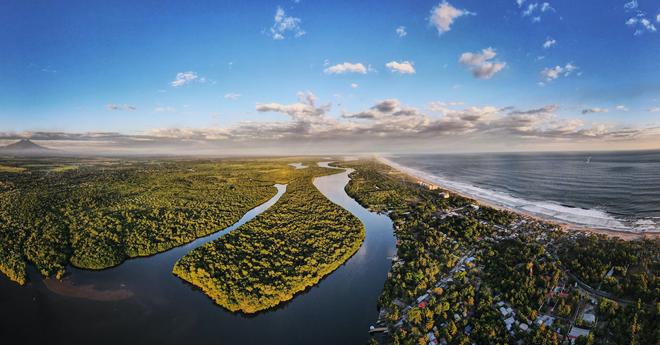 Landscape of El Salvador from above with river and seashore 