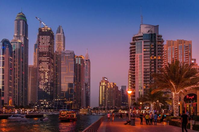 The night city of Dubai displaying a canal and skyscrapers